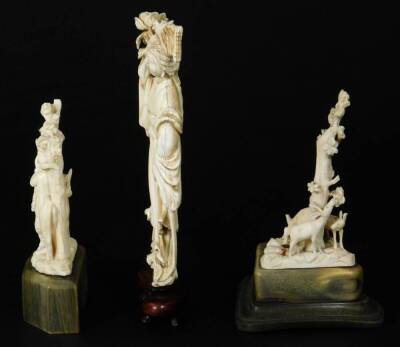 A late Meiji period ivory figure, of a standing Geisha in flowing robes holding floral staff, on a wooden base, 16cm H and two further ivory carvings. (3) - 2