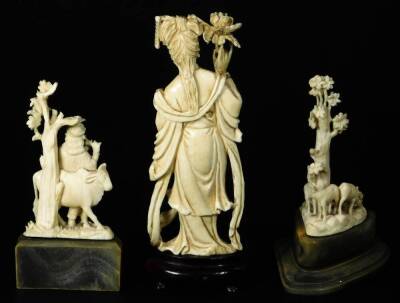 A late Meiji period ivory figure, of a standing Geisha in flowing robes holding floral staff, on a wooden base, 16cm H and two further ivory carvings. (3) - 3