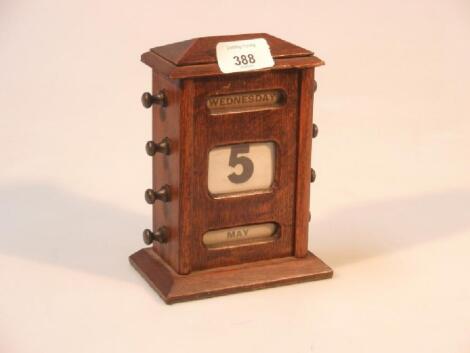 An early 20th oak cased perpetual calendar