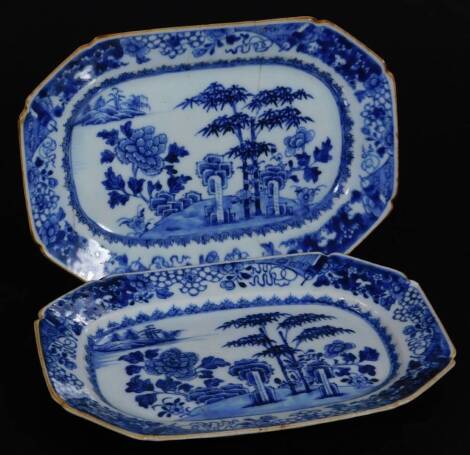 A pair of 18thC Chinese blue and white porcelain export dishes, each of octagonal form decorated with trees before water, on unglazed bases, 25cm W.