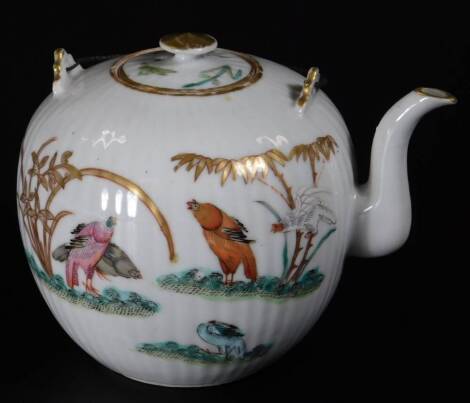 An oriental porcelain teapot, the bulbous ribbed body decorated with exotic birds in a naturalistic setting with gilt highlights predominately in orange and green, unmarked, 15cm H.