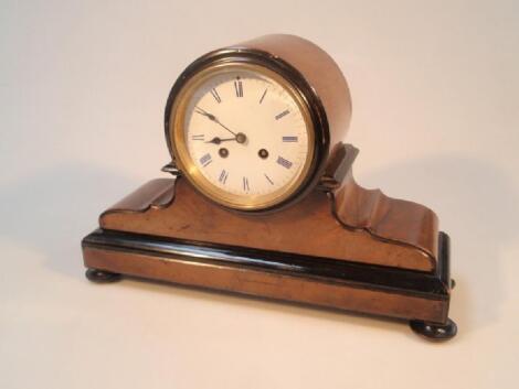 A Victorian ebonised and walnut balloon mantel clock