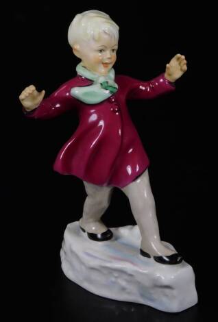 A Royal Worcester figure, representing January's child, wearing a crimson coat, no. 3452, by F.C. Doughty, black marked, 16cm H.