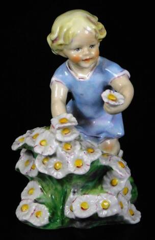 A Royal Worcester figure, representing May's child, wearing a blue dress and picking flowers, no. 3456, by F.C. Doughty no. 3455, black marked, 13cm H.