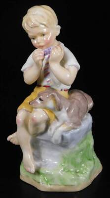 A Royal Worcester figure, representing June's child, wearing yellow shorts with dog, no. 3456, by F.C. Doughty, black marked, 16cm H.