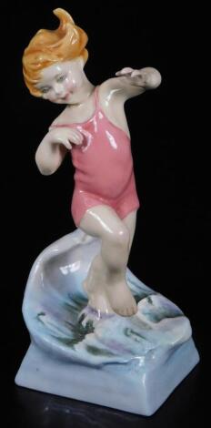 A Royal Worcester figure, representing July's child, wearing a pink swimsuit, by F.C. Doughty, no. 3440, black marked, 18cm H.