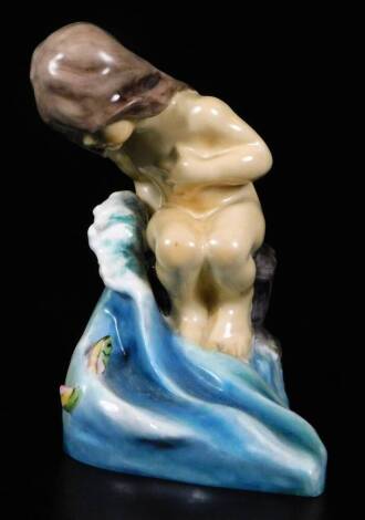 A Royal Worcester figure, representing August's child, sitting in the sea, no. 3441 by F.C. Doughty, 12cm H.