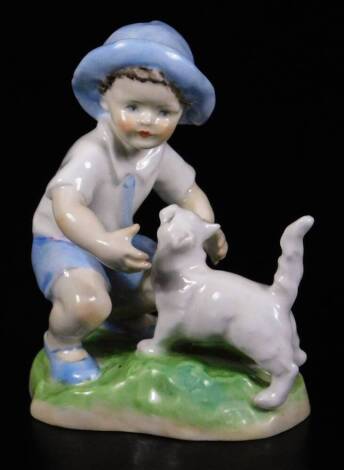 A Royal Worcester figure, representing September's child, wearing blue shorts with a cat, no.3457, by F.C. Doughty, black marked, 12cm H.