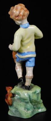 A Royal Worcester figure, representing October's child, wearing a yellow pullover and blue shorts with red squirrels, no. 3417, by F.C. Doughty, black marked, 19cm H. - 2