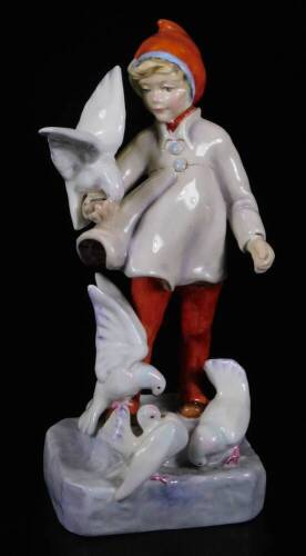 A Royal Worcester figure, representing November's child, wearing red trousers with white doves, no. 3416, by F.C. Doughty, black marked, 18cm H.