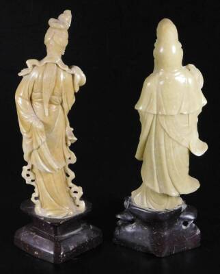 Two jadeite style figures, of females, the first in flowing robes holding bottle, on inverted base, 30cm H, the second holding fan. (2) - 3