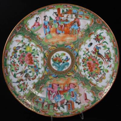 A pair of 19thC Cantonese famille rose plates, each decorated with panels of figures in interior scenes and centred by a section of flowers, predominately in pink, green and orange, 25cm Dia. with R N Myers receipt. - 2