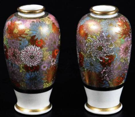 A pair of late Meiji period Japanese Satsuma vases, each of shouldered circular form, decorated with flowers predominately in orange, green and white, with gilt highlights, three character mark beneath, 14cm H.