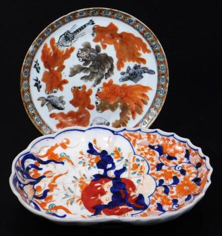 An 18thC oriental saucer, of circular form, decorated with fish, in orange with an outer geometric floral border, 15cm Dia., and an Imari plate of shaped form. (2)