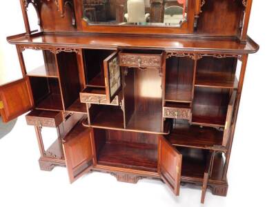 An exceptional 19thC Edwards & Roberts Japonesque rosewood Shodhana cabinet, the mirror inset aesthetic movement superstructure with an arrangement of canopied shelves on carved brackets, the top of the lower part with curved ends, having six doors with o - 2