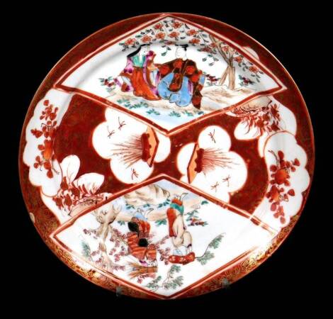 A 19thC Japanese Kutani plate, of circular form, decorated with panels of figures and flowers with gilt highlights, predominately in orange picked out in green, six character mark beneath, 18cm Dia.