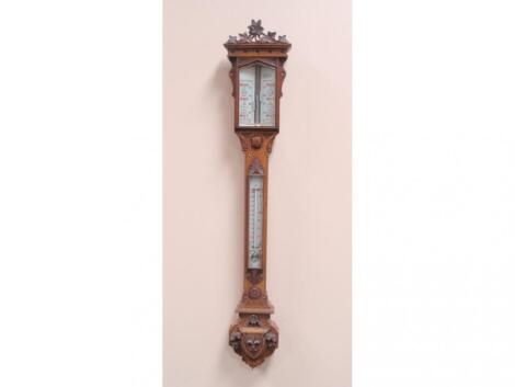 A Victorian carved oak stick barometer