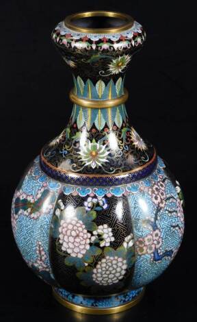 A Chinese Qing period cloisonné vase, of floral form with cylindrical stem, profusely decorated with flowers, predominately in pink, green and blue, on a black ground with gilt highlights, 54cm H.