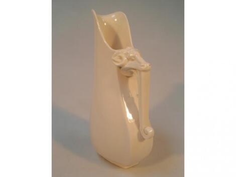 A Royal Worcester porcelain ivory jug of stylised design with a ram's head terminal handle