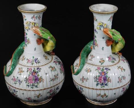 A pair of Samson hard paste porcelain bottle vases, of fluted form decorated with curling dragons, the body decorated with flower groups, false seal marks, 32cm H. (2)