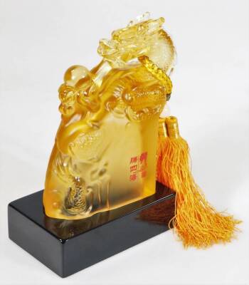 A Chinese amber coloured glass figure of a dragon, stamped and named to the front, on a plinth base, 24cm H. (boxed) - 2