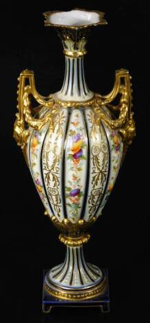 A 19thC porcelain vase, with trumpet stem pierced angular handles, and shouldered ribbed body, hand painted with flowers with gilt highlights on an inverted stem and square foot, unmarked, 36cm high.