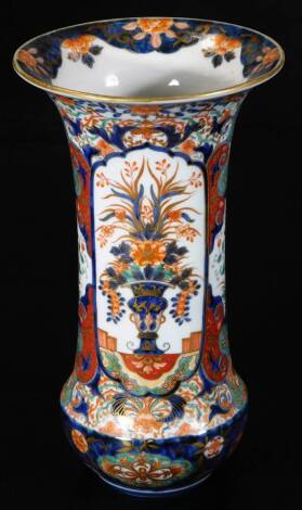 A Japanese Imari cylinder vase, with flared rim and decorated in an elaborate basket pattern within panels in traditional colours of red, blue and gilt, marked base, 30cm H.