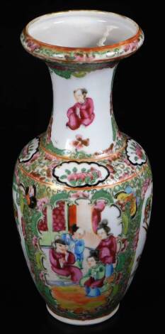 An early 20thC Cantonese famille rose vase, of shouldered form, with trumpet stem, profusely decorated with flowers, predominantly in pink, green and black, 25cm H.