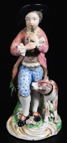 An early 19thC Derby porcelain figure of a musician, aside dog on a bocage base, polychrome decorated, predominately in pink, blue and green, with gilt highlights, numbered N58, beneath, 16cm H.