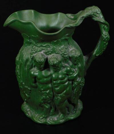 A 19thC Minton type Bacchus and cherub jug, in green glaze, raised with various figures, raised ribbon mark beneath, 17cm H.