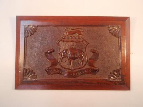 A 19thC carved mahogany panel with armorial and motto 'camera principis'