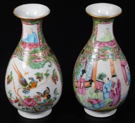 A pair of 19thC Cantonese pottery famille rose vases, each with trumpet stems and bulbous bodies, decorated with panels of birds predominantly in pink, green and orange, unmarked. 18cm H. (2)