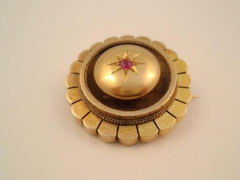 A Victorian circular memorial brooch with vacant window verso