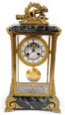 A 19thC French mantel clock, with elaborate marble gilt metal case, surmounted by quill and garland, above a four sided glass section, on scroll feet, holding a 11cm Dia. dial, signed HII MARC Paris, Roman numeric dial, pendulum swung movement striking on