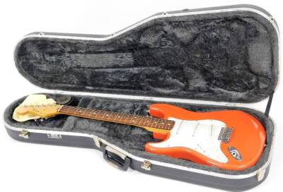 A Fender Stratocaster left handed electric guitar, in orange and white colour way, MZ0224402, 59cm W. (cased)