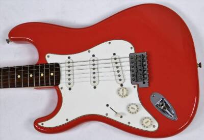 A Fender Stratocaster left handed electric guitar, in orange and white colour way, MZ0224402, 59cm W. (cased) - 2