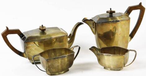 A George V silver Art Deco four piece tea service, with a diamond sun motif to the coffee pot, teapot, two handled sugar bowl and milk jug, Sheffield 1931, 64oz all in. (4)