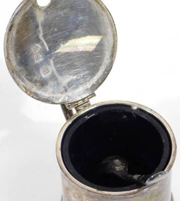 A Victorian silver mustard pot, of cylindrical form, with thumb mould top, shaped handle, blue glass liner and associated spoon, 2½oz. - 3