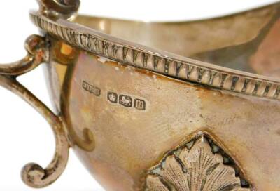 An Edwardian silver sauce boat, of cape form, with a repeat geometric banding, acanthus capped S scroll handle and triple acanthus leaf hairy paw feet, Sheffield 1904, 10cm H, 8oz. - 2