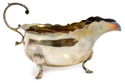 A George V silver sauce boat, with flared rim, S scroll handle, triple shell capped hoof supports, Lambert retailer's mark, London 1912, 9cm H, 5½oz.