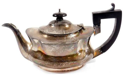 A George V silver bachelor's teapot, of shaped cape form, with ebonised knop, angular thumb mould handle and oval foot, Birmingham 1912, 14cm H, 10oz.