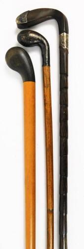 A very early 20thC walking stick, with plain stem and golf club horn top and tip, a walking cane with silver collar and tip and another golf club shaped walking cane. (3)