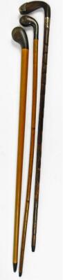 A very early 20thC walking stick, with plain stem and golf club horn top and tip, a walking cane with silver collar and tip and another golf club shaped walking cane. (3) - 2