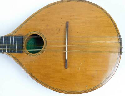 An early 20thC mandolin, of shaped form, with one piece polished back, ebonised end with articulated tuning knops, labelled International College of Music, sold only by The International College of Music, 230 Edgware Road, London W, 61cm W. (cased) - 3