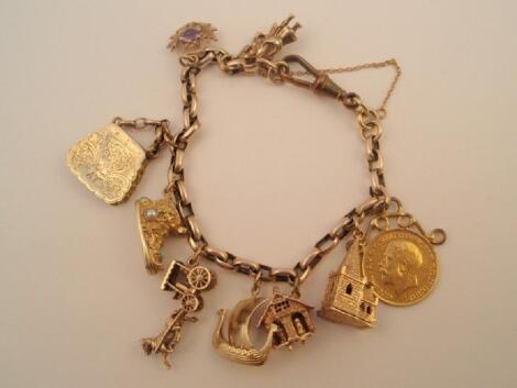 A charm bracelet with ten attached charms (various grades)