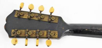 An early 20thC mandolin, of shaped form, with one piece polished back, ebonised end with articulated tuning knops, labelled International College of Music, sold only by The International College of Music, 230 Edgware Road, London W, 61cm W. (cased) - 6