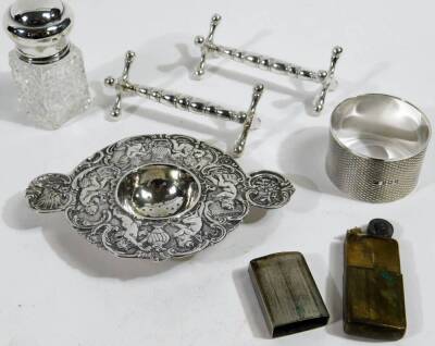 Various silver and effects, to include a George V silver napkin ring, engine turned, Birmingham 1929, 5cm Dia. 1oz, a tea strainer heavily repoussé decorated with pierced centre, two knife rests, silver topped glass jar, pocket lighter, early 19thC Crown - 3