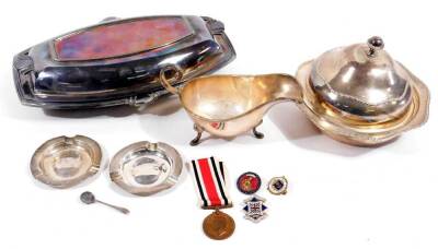 Various silver plated ware, sauce boat, 10cm H, muffin dish, Art Deco entree dish, George VI Faithful Service medal, marked J M Asquith, two silver ash trays, etc. (a quantity)