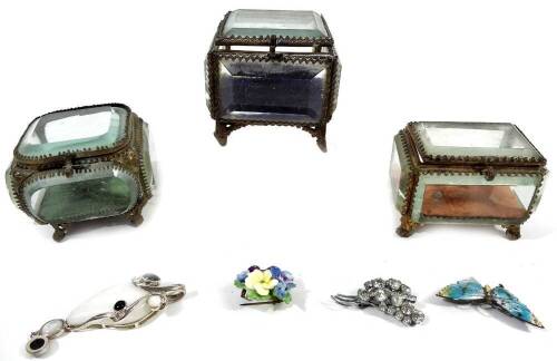 Three early 20thC glazed jewellery caskets, with five sided glass panelling and velvet lined interior, on shaped metal feet, 7cm H, 8cm W, 8cm D, etc. and various jewellery, a silver and enamel butterfly brooch, floral brooch, costume jewellery, etc. (a