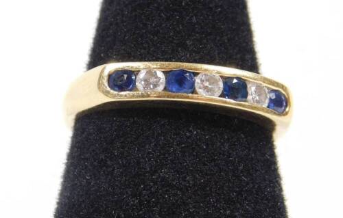 An 18ct gold half hoop eternity ring, set with sapphire and diamonds in tension setting, ring size N, 3.9g all in.